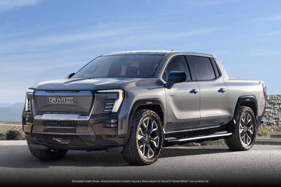 Three-Quarters View of a Parked GMC Sierra EV under a Clear Blue Sky