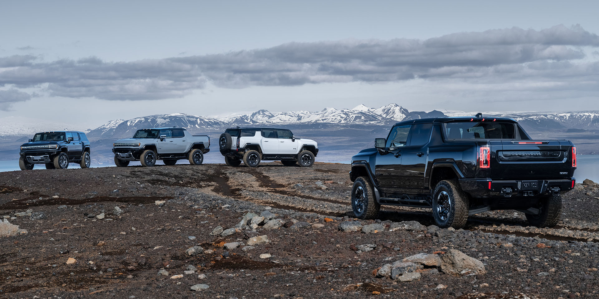 2025 GMC Hummer EV SUV off-roading on desert terrain