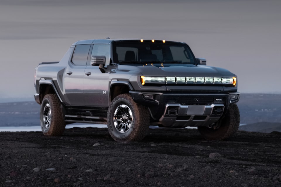 Three-Quarters View of a GMC Hummer EV Pickup Truck under an Evening Sky 