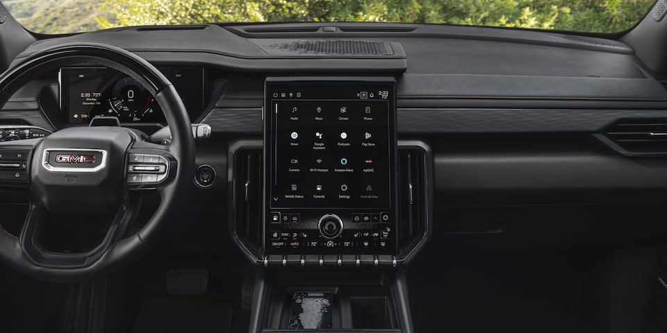 Interior View of the GMC Acadia AT4 Steering Wheel, Infotainment System, and Dashboard