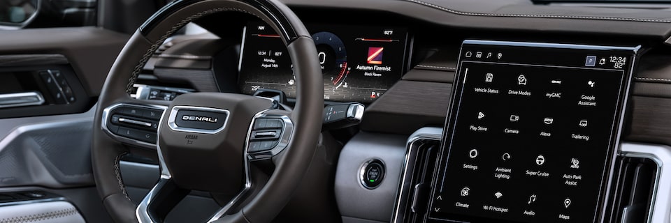 Passenger Side Interior View of the Steering Wheel and Infotainment System in the GMC Acadia