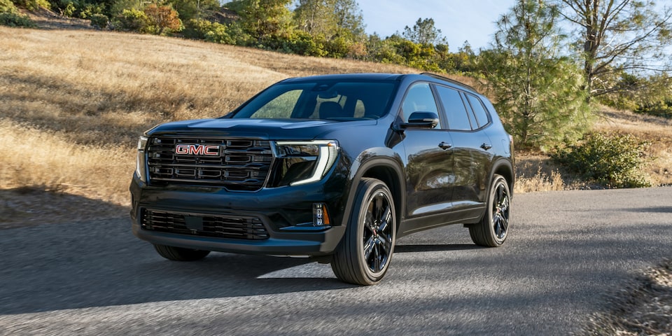 The GMC Acadia Mid-Size SUV Driving Down the Road