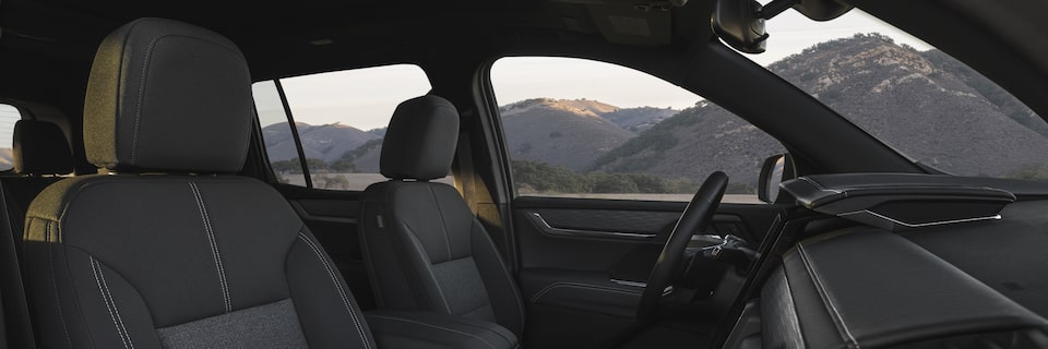 Passenger Side View of the Interior Front Row Seating of the GMC Acadia Mid-Size SUV