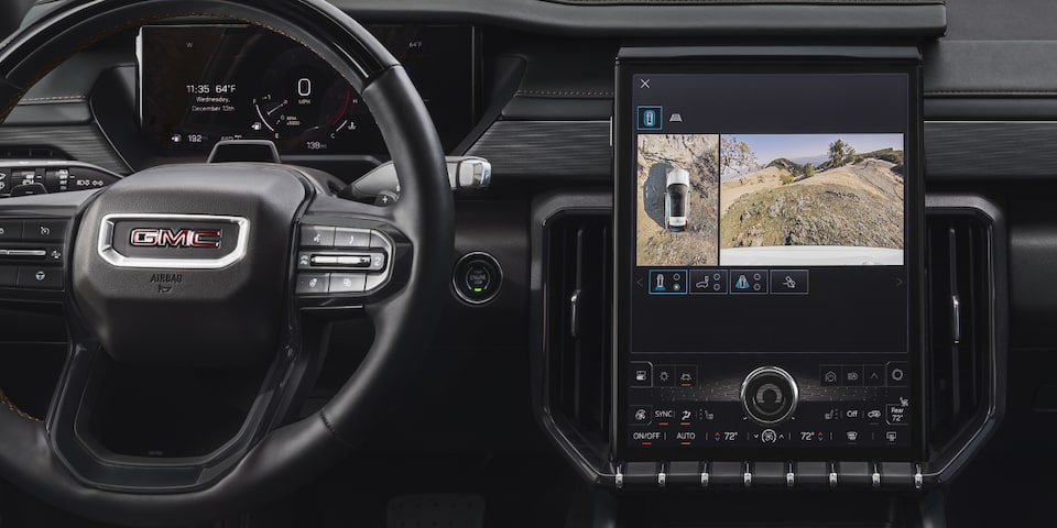 Interior View of the GMC Acadia Steering Wheel, Infotainment System, and Dashboard