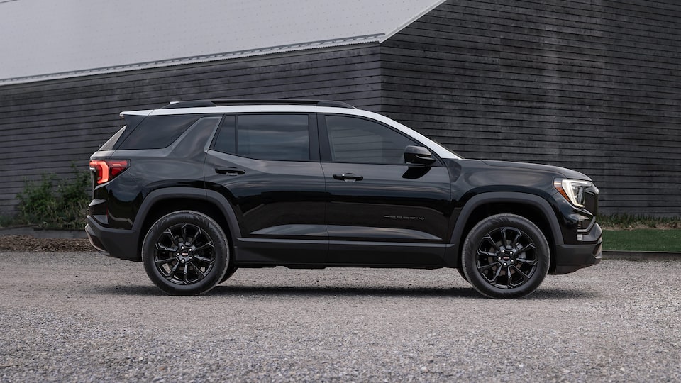 Profile View of the 2025 GMC Terrain Small SUV Parked in Front of a Building