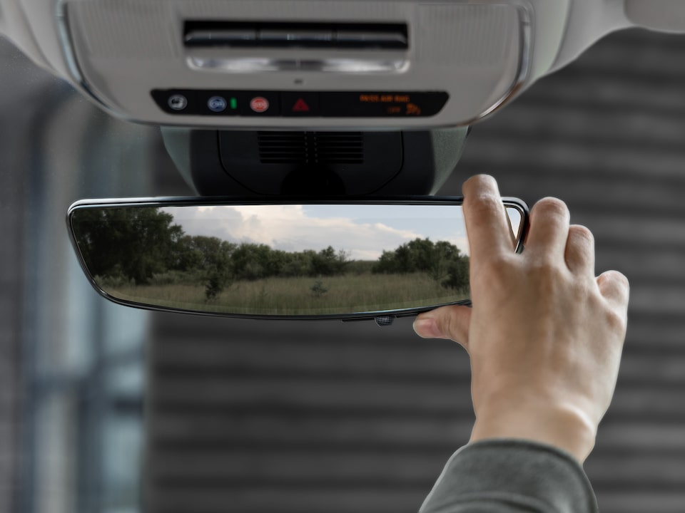 Close-up of a Man Adjusting the GMC Terrain Rear View Mirror