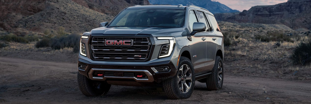 Front Three-Quarter View of the GMC Yukon Large SUV Parked in the Desert at Sunset