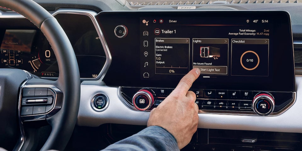 Close-up of a Driver Utilizing the ProGrade Trailering System on the GMC Canyon's Display Screen