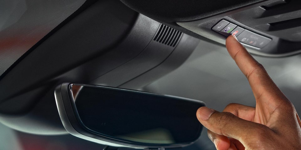 Close-up of Somebody Pressing the OnStar Button on a GMC's Interior Roof