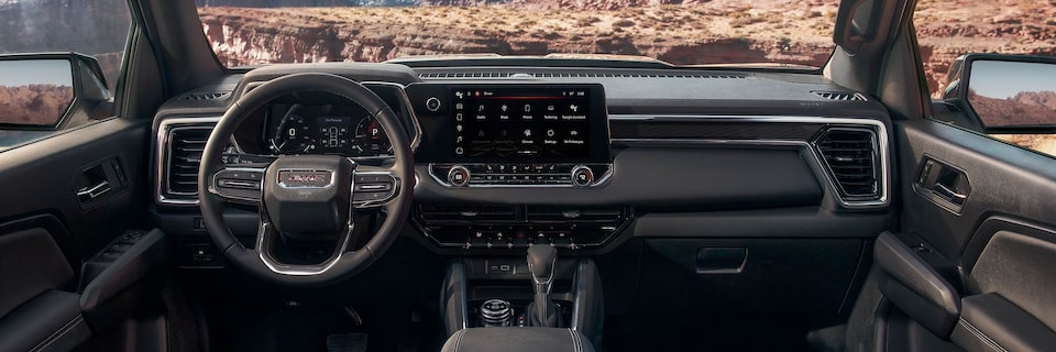 The 2025 GMC Canyon Elevation Front Interior with Steering Wheel and Infotainment System
