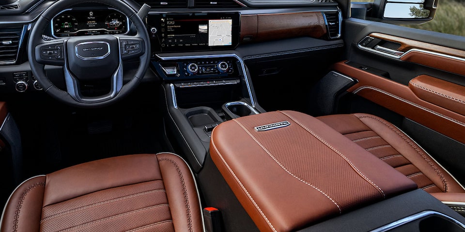 Close-up of the Front Seats, Center Console, Steering Wheel, and Infotainment System in a 2025 GMC Sierra HD Denali Truck