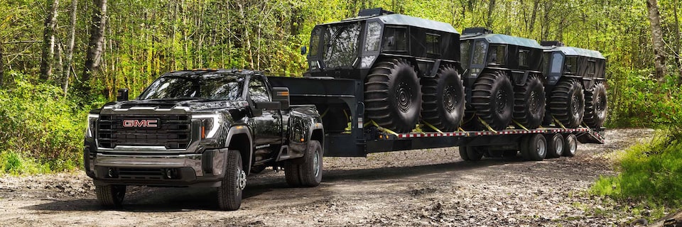 Wide View of a 2025 GMC Sierra HD Truck Hauling a Trailer