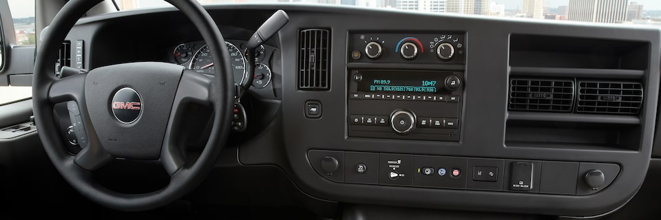 Wide Interior View of the Steering Wheel and Dashboard in a 2025 GMC Savana Passenger Van
