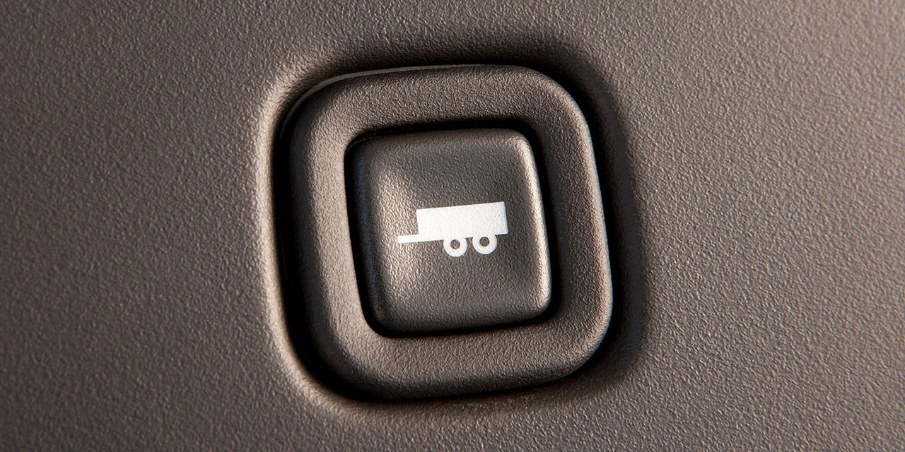 Close-up of the Towing and Hauling Mode Button in a 2026 GMC Savana Cargo Van