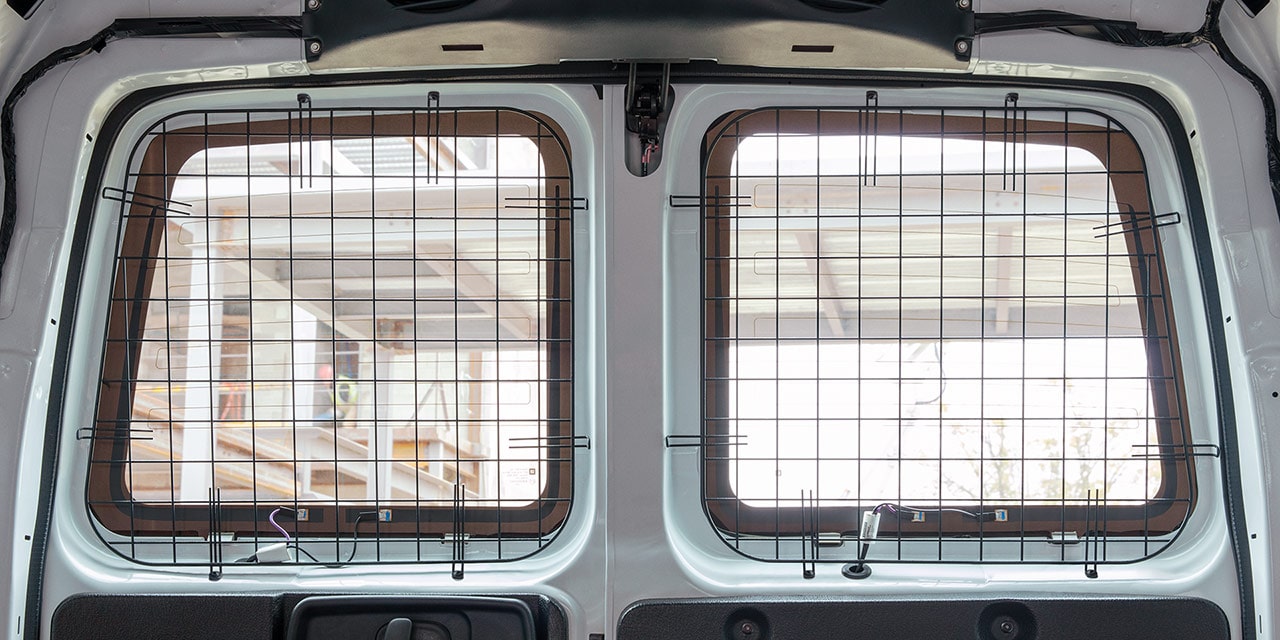 Interior View from the Rear of a 2026 GMC Savana Van, Highlighting the Security Grilles on the Windows