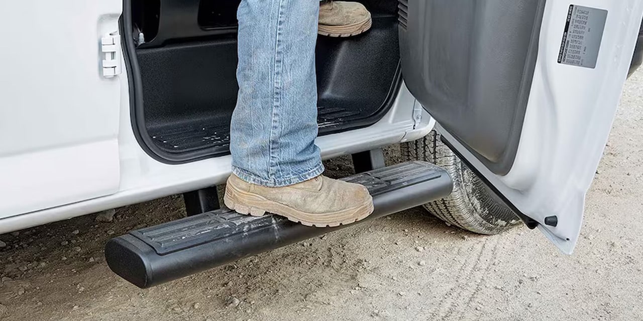 Close-up of a Person Getting out of a 2026 GMC Savana Work Van Using the Exterior Accessory Step