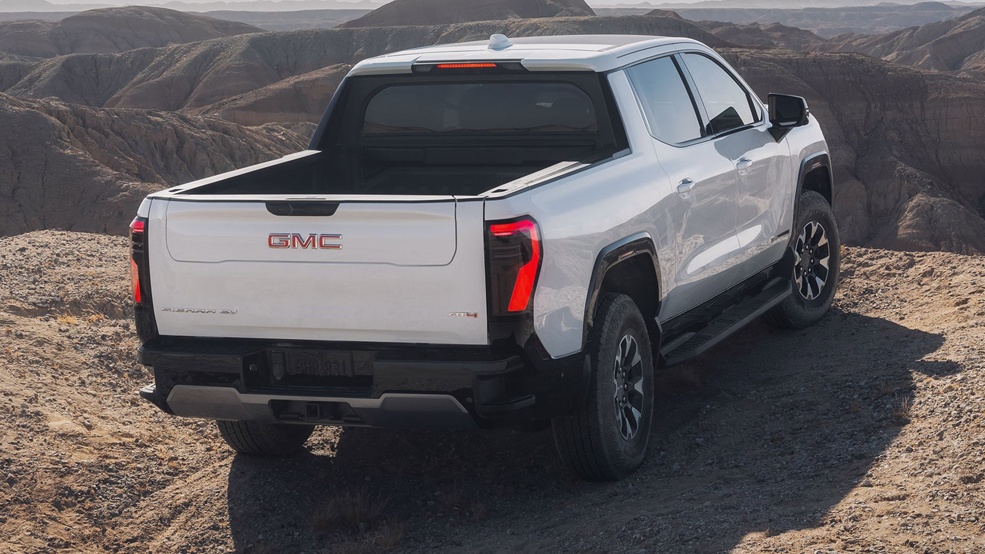 Rear View of the 2026 GMC Sierra EV AT4 Pickup Truck Parked on the edge of a Cliff
