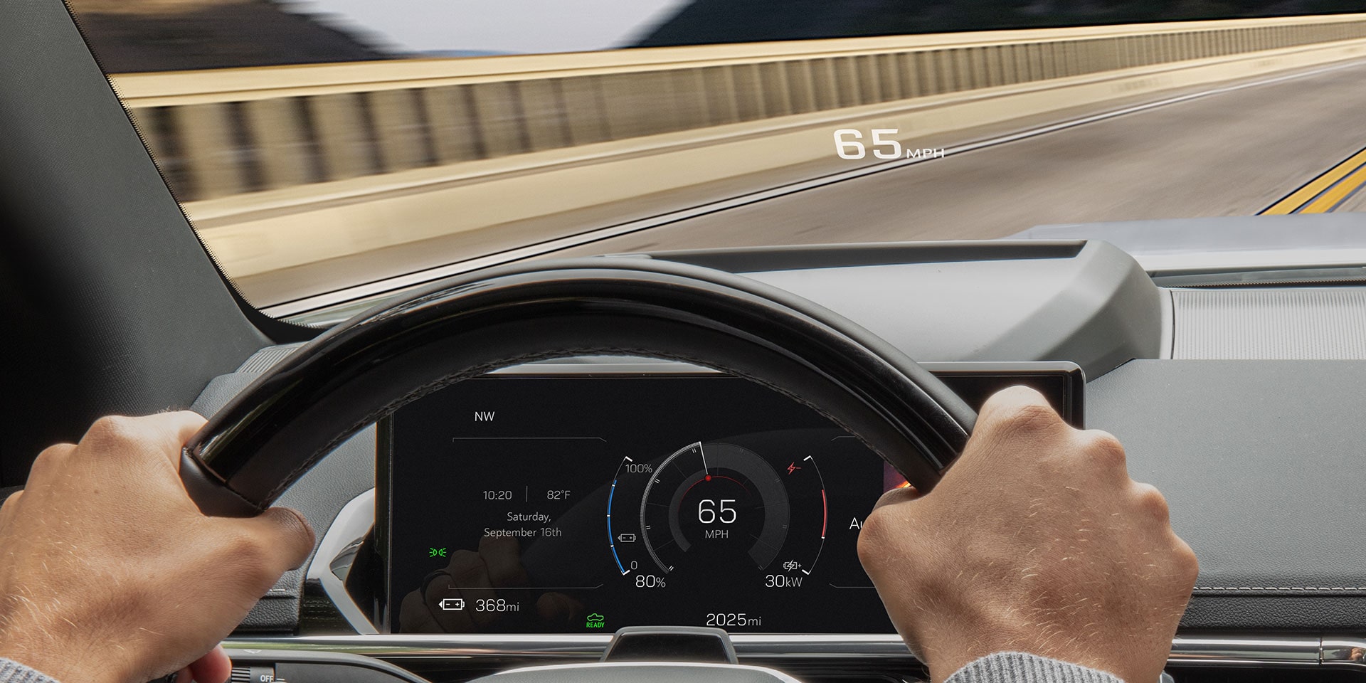 The Head-up Display Feature Being Used as a Man Drives his 2026 GMC Sierra EV AT4