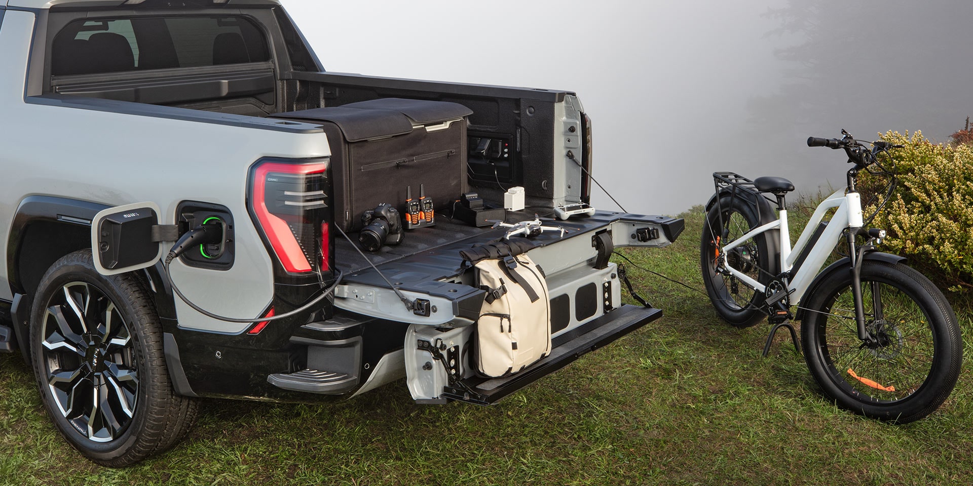 The Ebike Parked Next the Open Tailgate of a 2026 GMC Sierra EV AT4