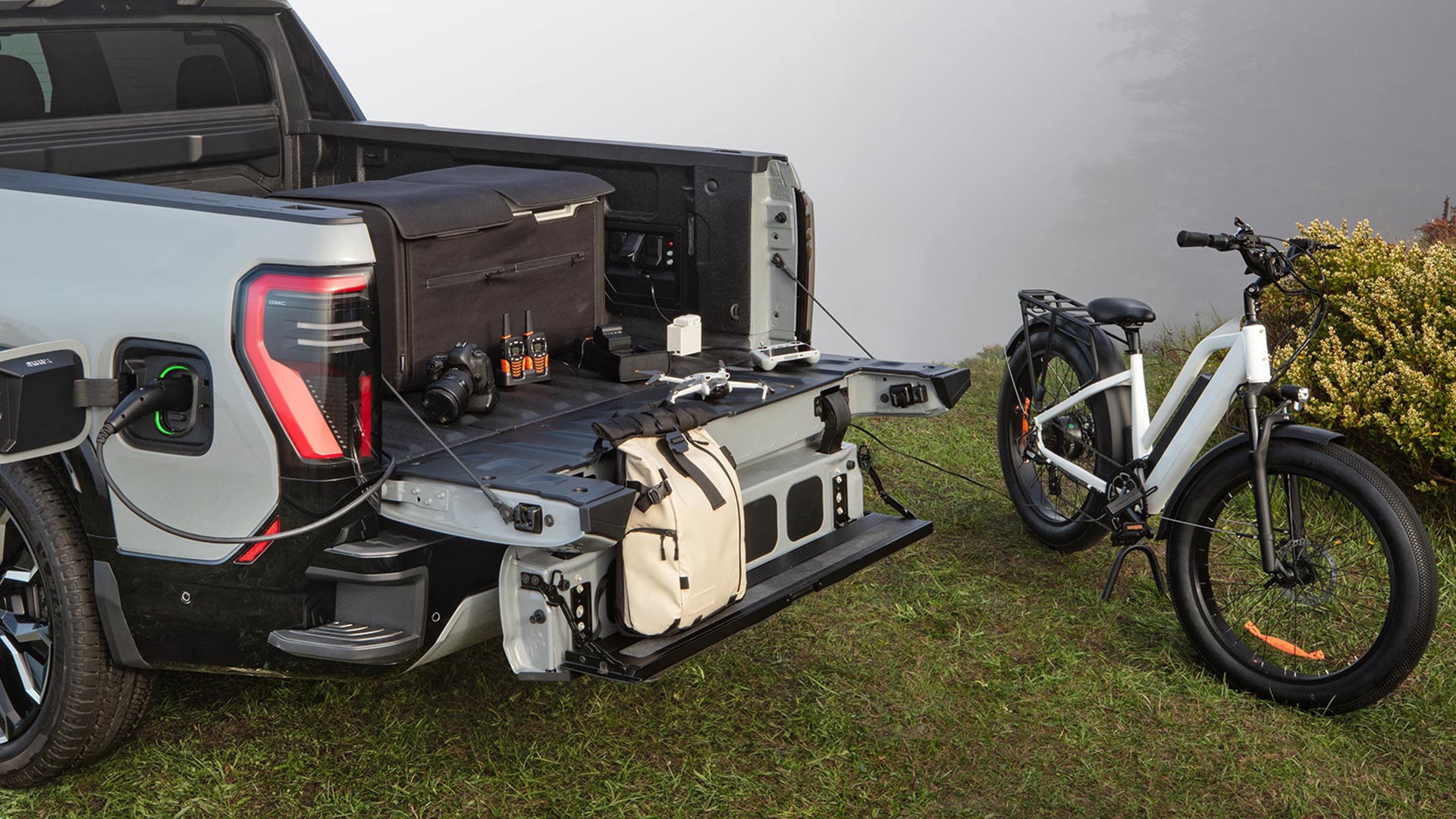 The Ebike Parked Near the Opened Tailgate of the 2026 GMC Sierra EV Denali