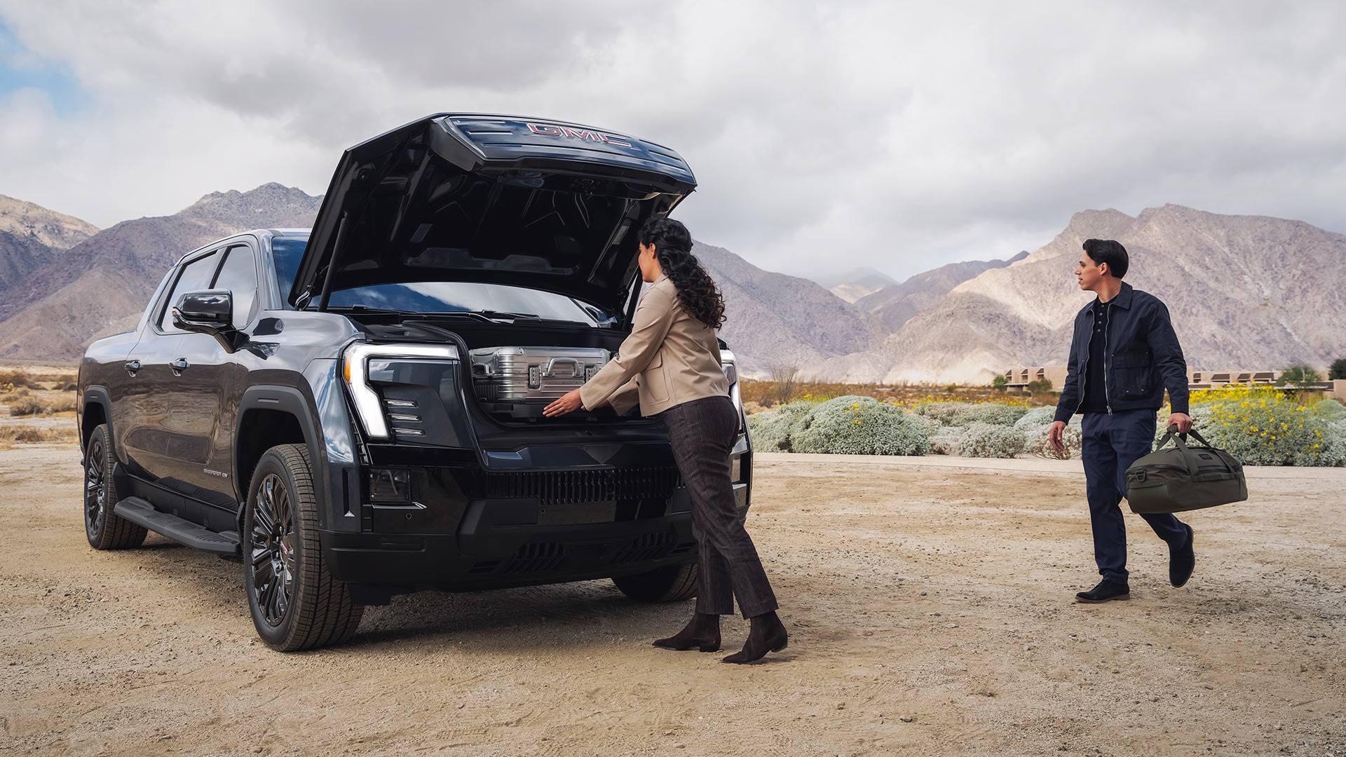 A Couple Loading the Under-hood Storage in the 2026 Sierra EV Elevation