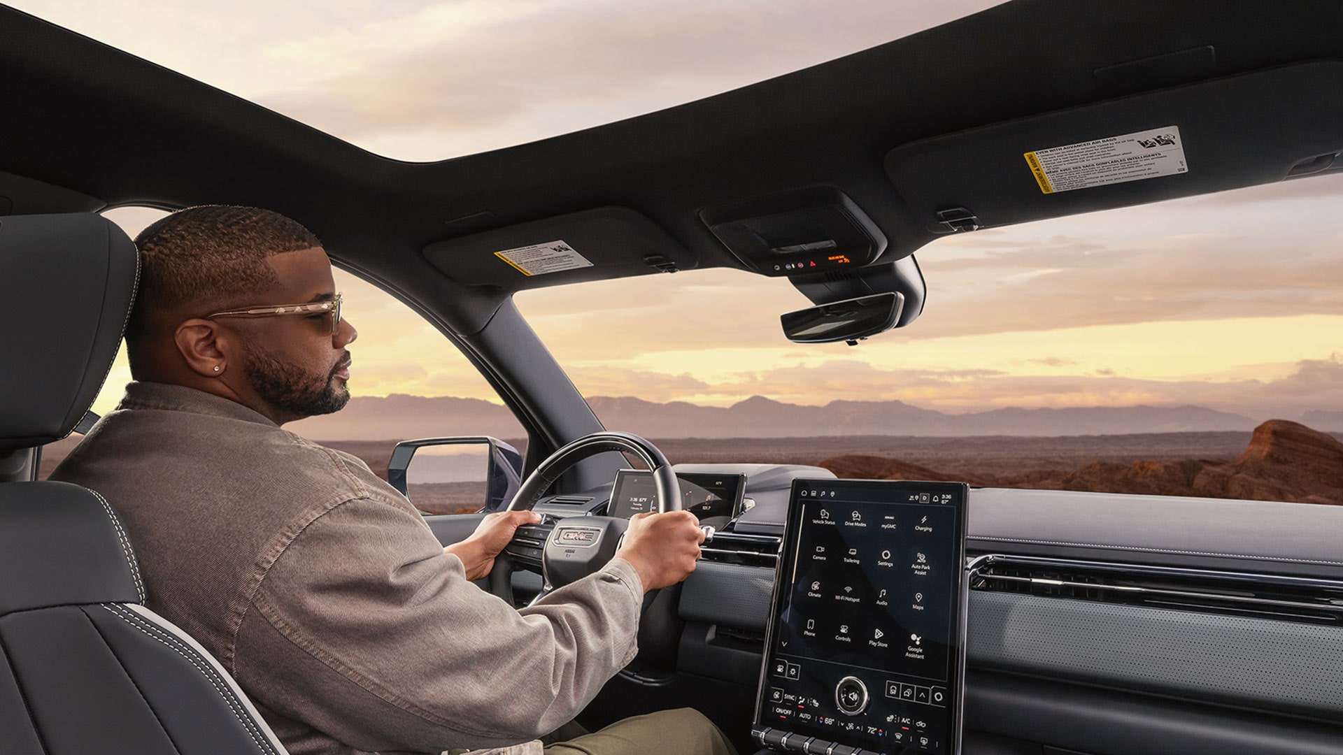 A Man Driving the 2026 GMC Sierra EV Elevation Pickup Truck Using Super Cruise