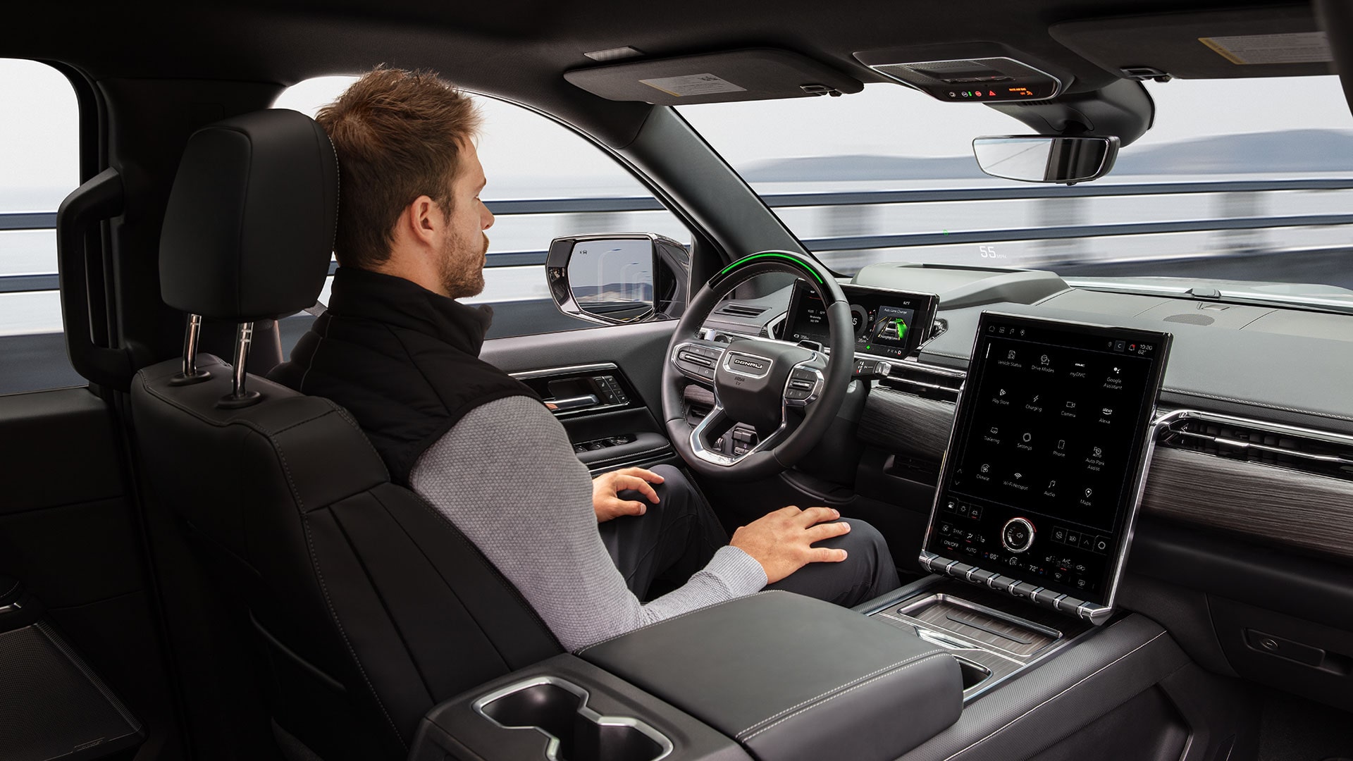 A Man Driving the 2026 GMC Sierra EV Hands-free Utilizing the Super Cruise Driver Assistance Technology