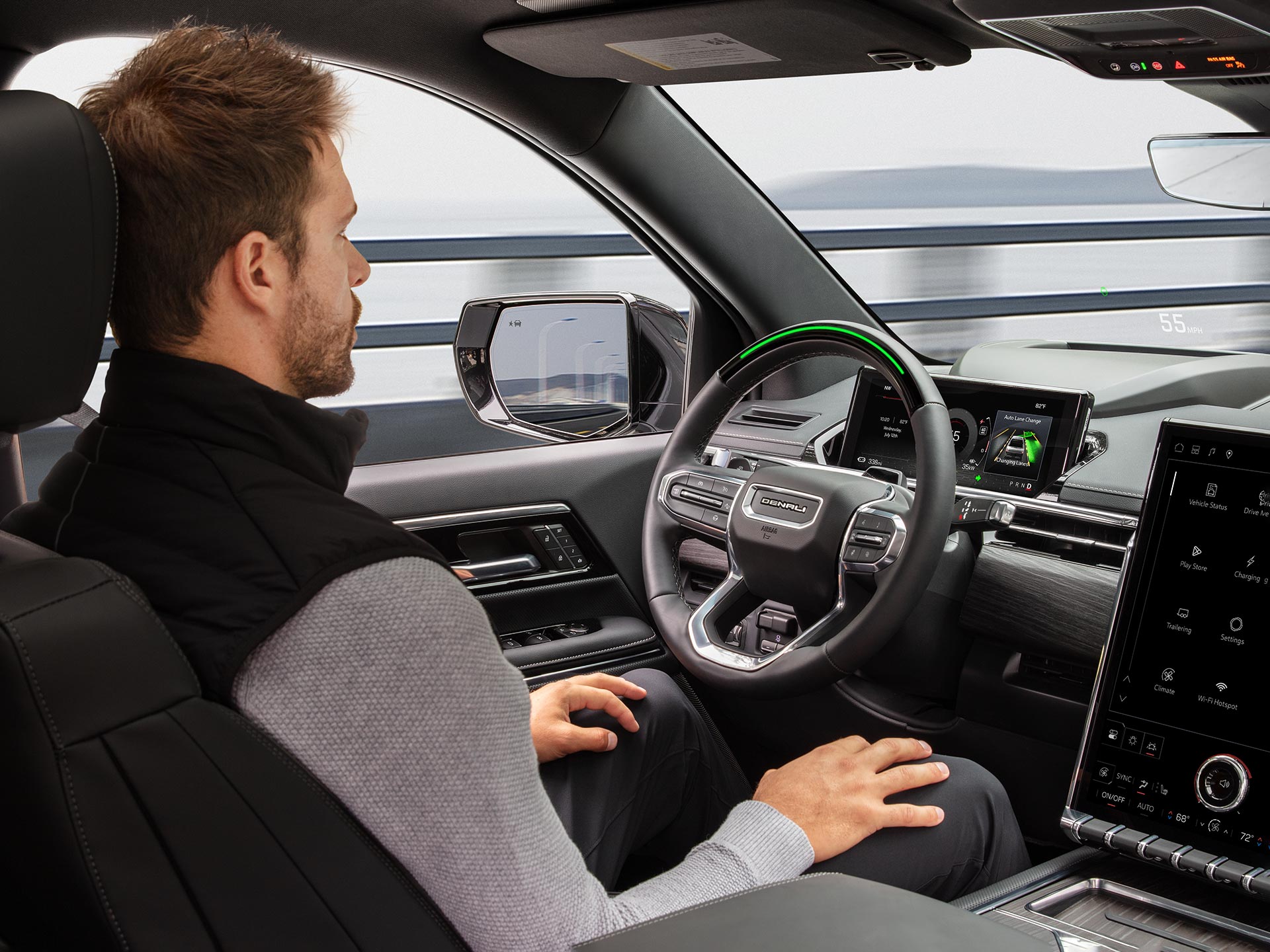 A Man Driving the 2026 GMC Sierra EV Hands-free Utilizing the Super Cruise Driver Assistance Technology
