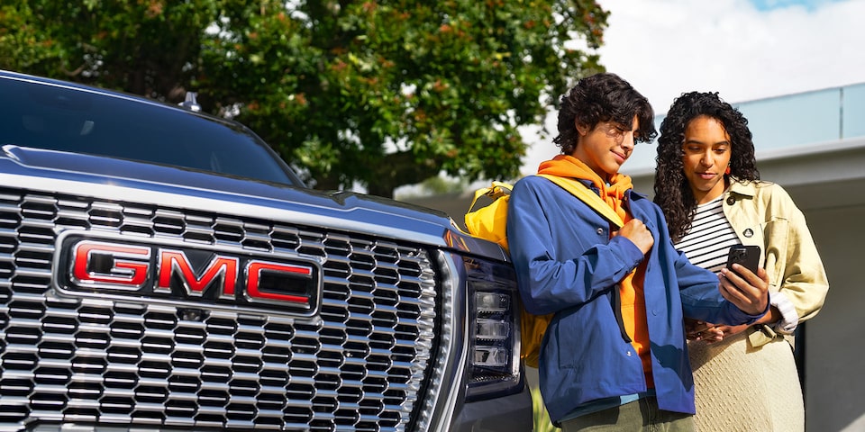 Close-up of Someone About to Press the OnStar Button near the Rear View Window
