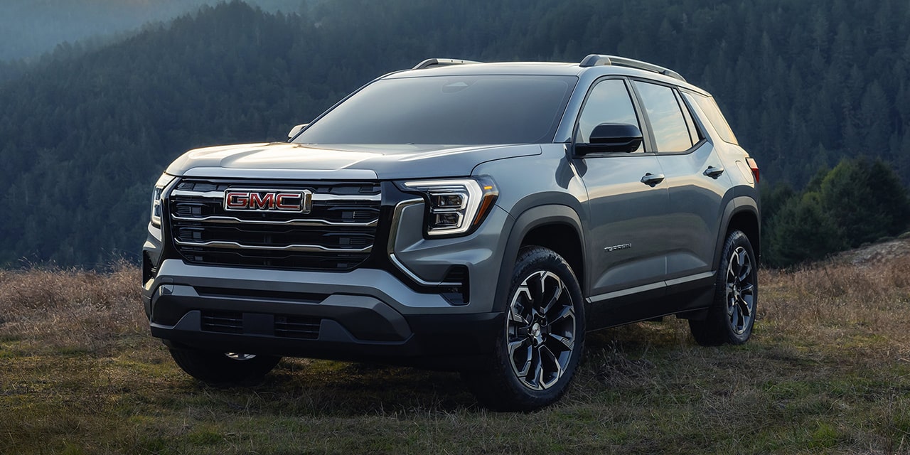Front Three-Quarter View of the 2026 GMC Terrain Elevation Compact SUV Parked on a Hill Top at Sunrise