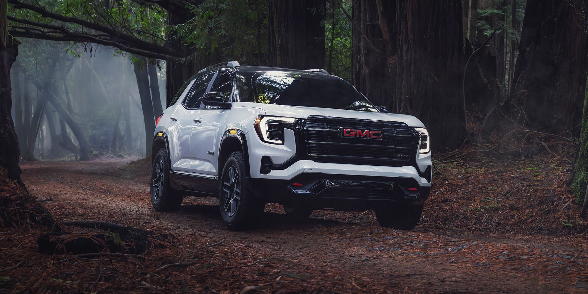 exterior of 2026 gmc terrain at4 driving on trail 