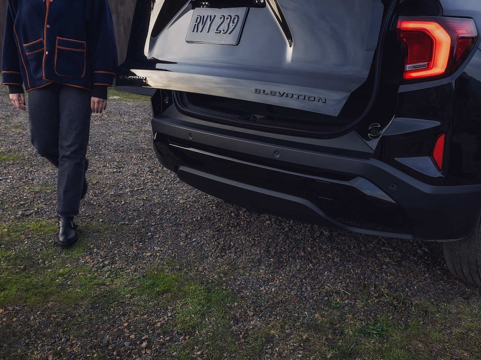 A Man Using the Autosense Power Liftgate on the 2026 GMC Terrain Small SUV