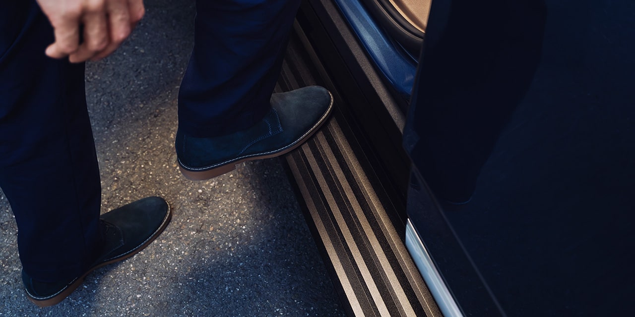 Close-up of a Man Using the Assist Step on the 2026 GMC Yukon