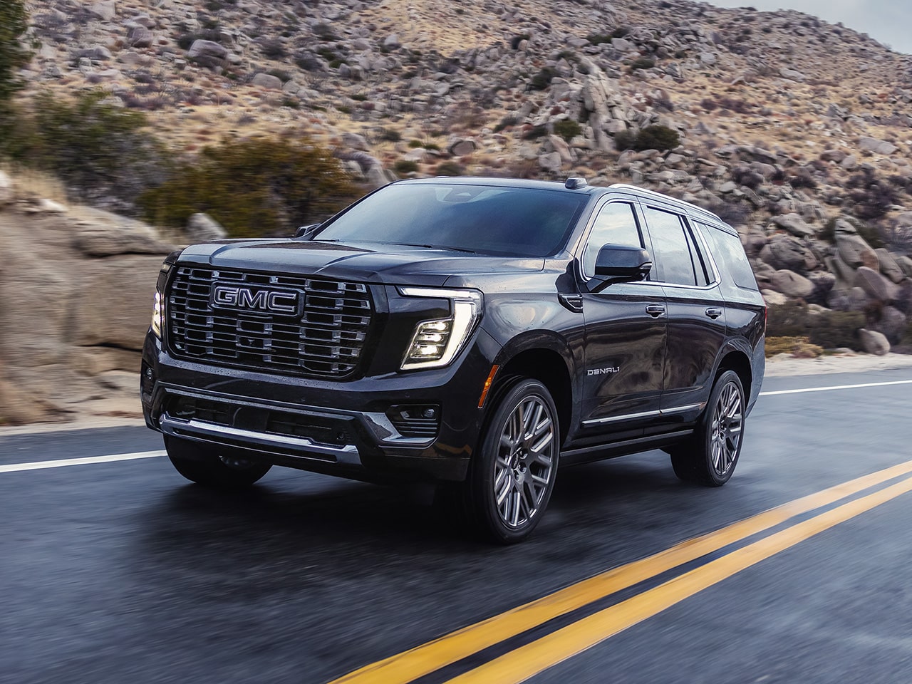 The 2026 GMC Yukon Denali Luxury 3 Row SUV Towing a Boat
