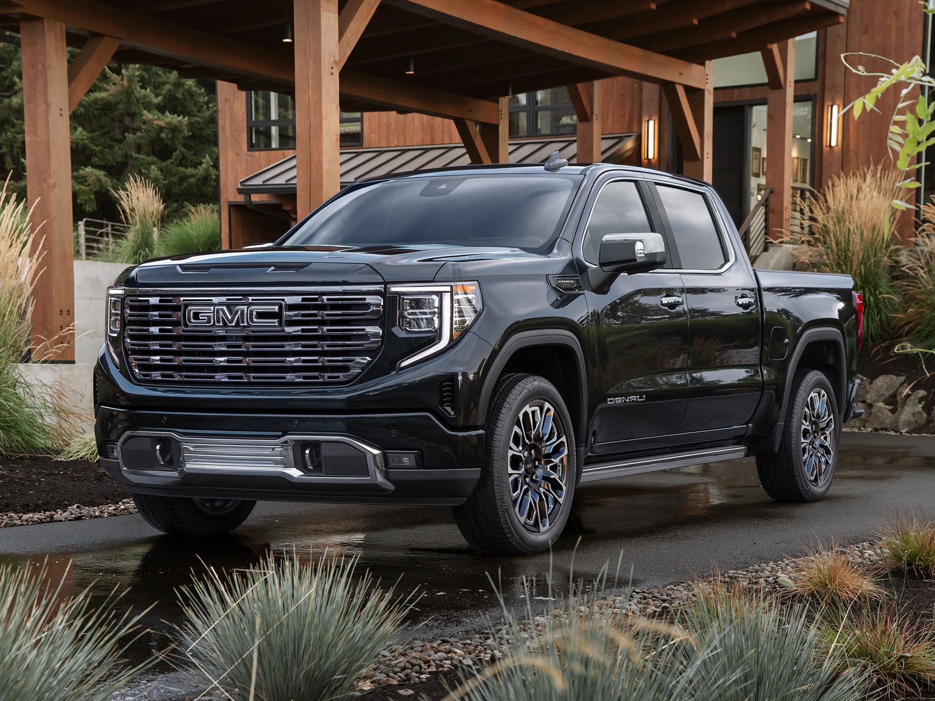 The 2026 GMC Sierra 1500 Pickup Truck Parked in the Driveway of a Beautiful Cabin in the Woods