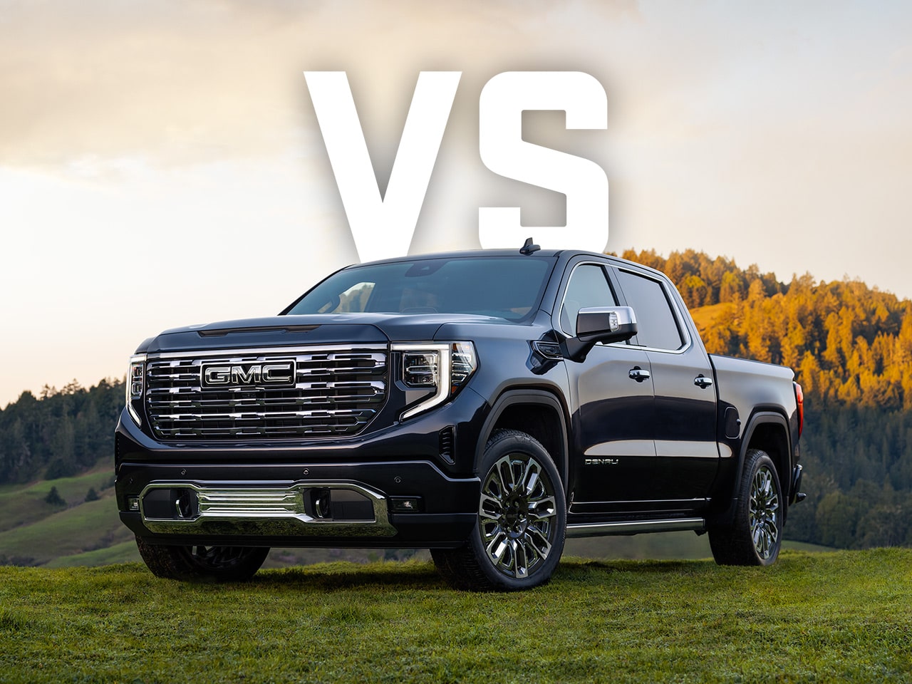 A Low Front View of the 2026 GMC Sierra EV Driving Through a Mountain Road