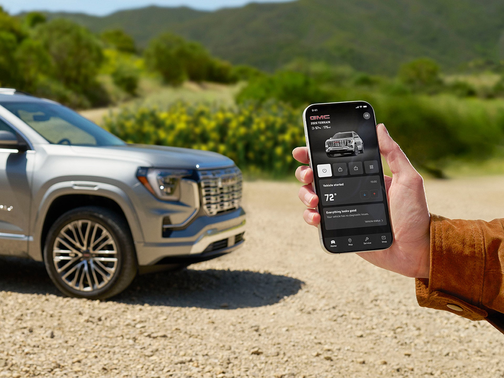 A Hand Holding a Smartphone Displaying the GMC Mobile Application with Vehicle Controls