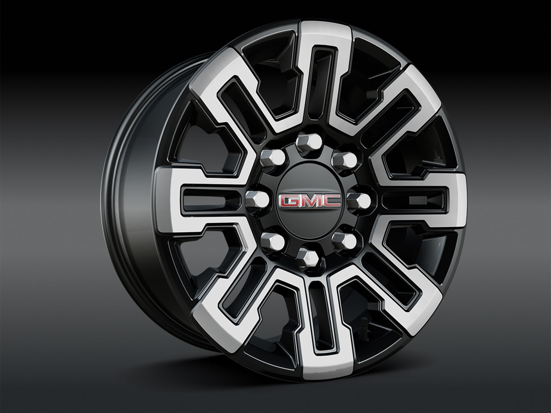 A Close Up of a Bold GMC Wheel Design Featuring Machine-faced Accents with Black Pockets