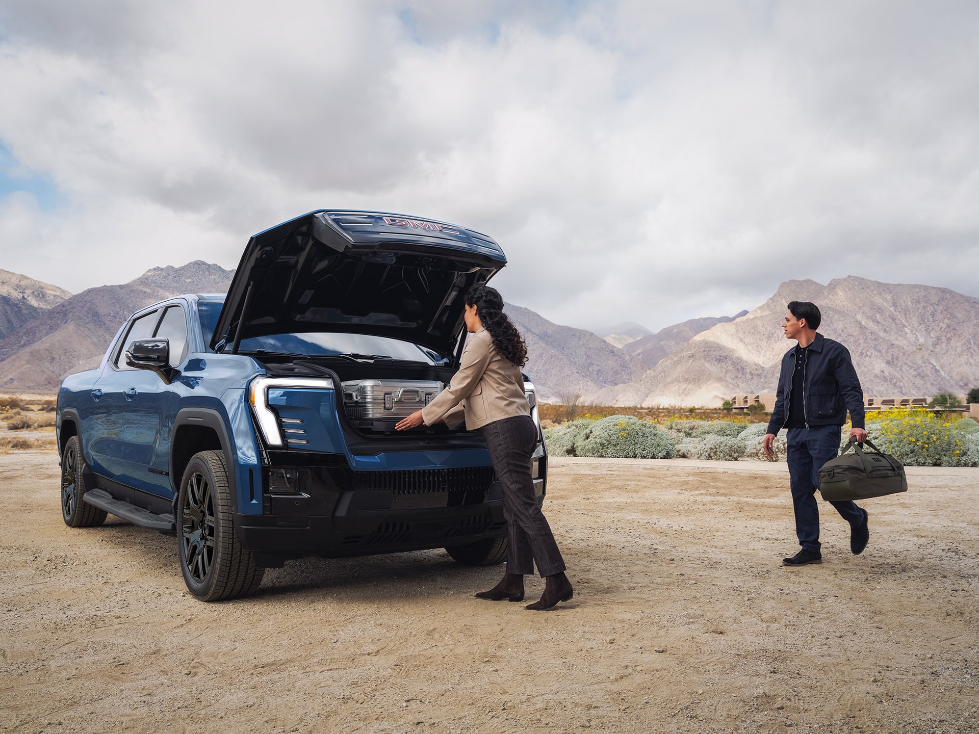 A Person Accessing the Spacious Front eTrunk of a Alue GMC Sierra EV Truck