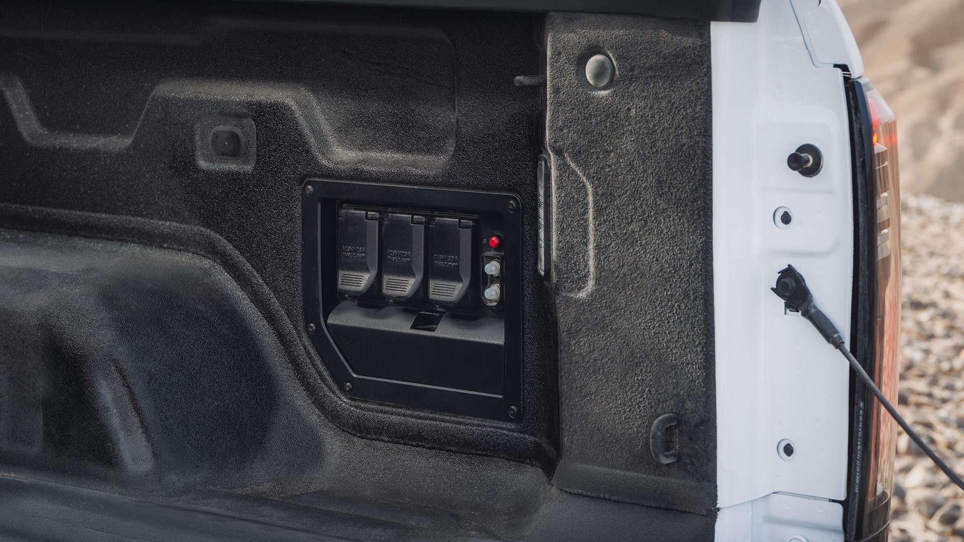 A Rugged GMC Sierra EV Truck Bed Featuring Durable Power Outlets for Enhanced Electrical Capability