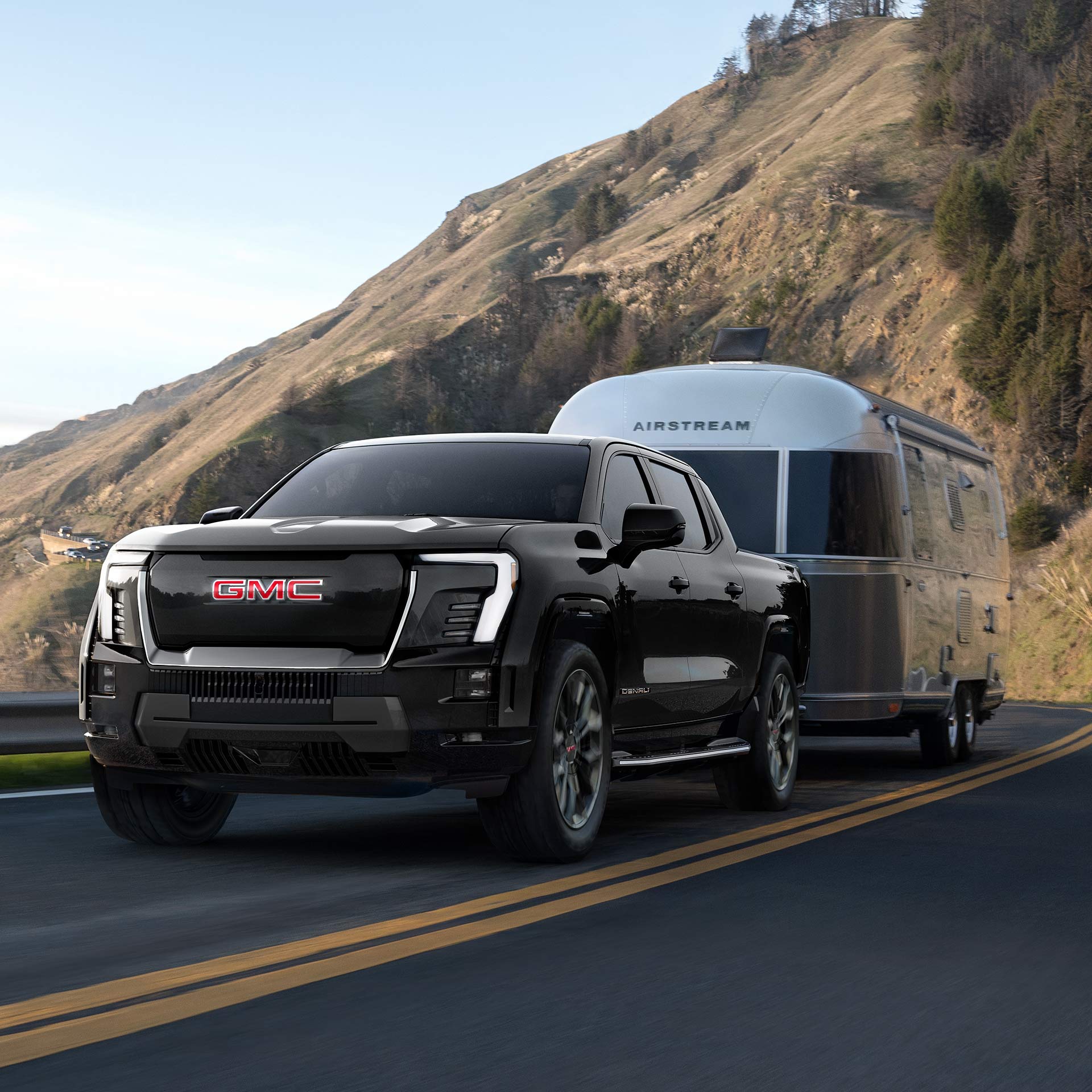 A Black GMC Sierra EV Denali Demonstrating Exceptional Towing Capability with an Airstream Travel Trailer