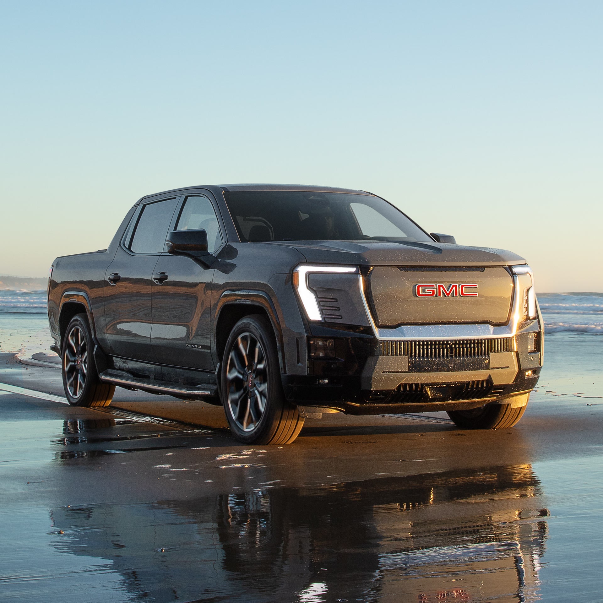 A Powerful GMC Sierra EV Denali Parked on the Beach Showcasing its Air Ride Capability