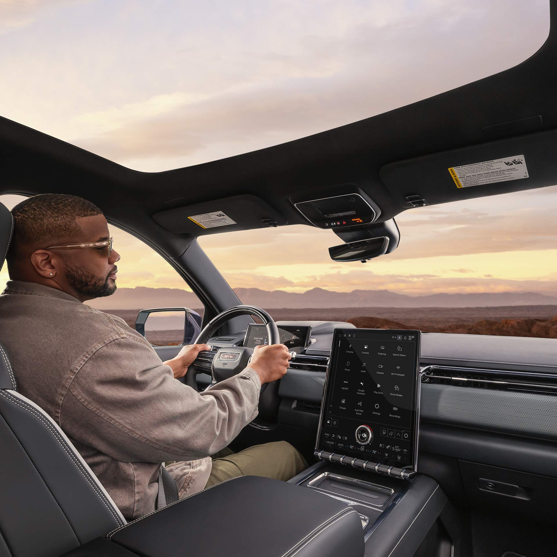 A Driver Experiences the Expansive Glass Sunroof in a Professional Grade GMC Sierra EV