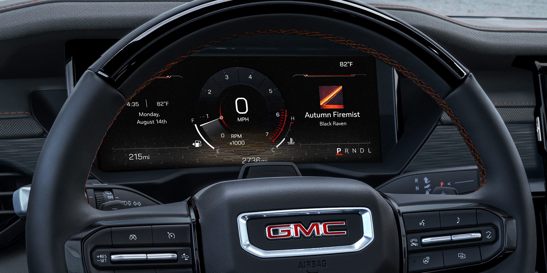 An Interior View of a GMC Steering Wheel with a Digital Dashboard Displaying Autumn Firemist Music