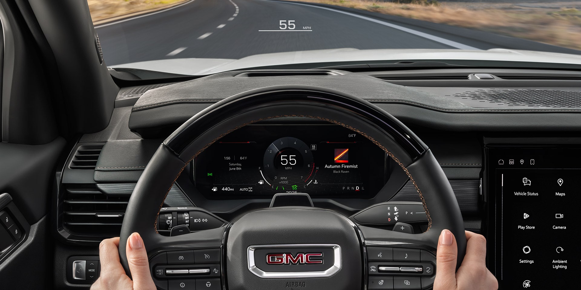 A Driver's Perspective Inside a GMC Vehicle, With Hands on The Steering Wheel, Showing The Digital Instrument Cluster and Road Ahead