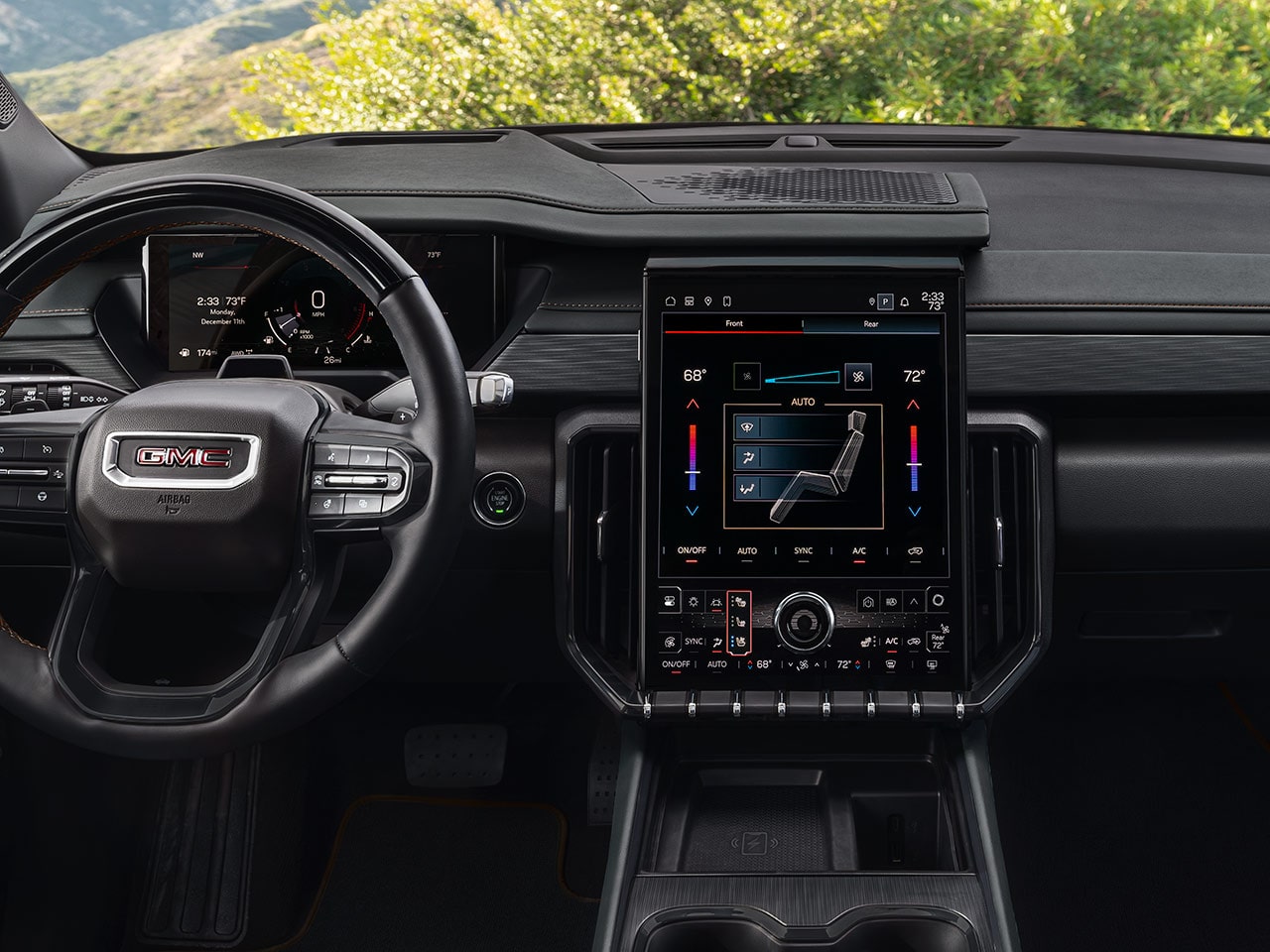 A Full Dashboard View of a GMC Vehicle Showing the Steering Wheel and Infotainment Screen