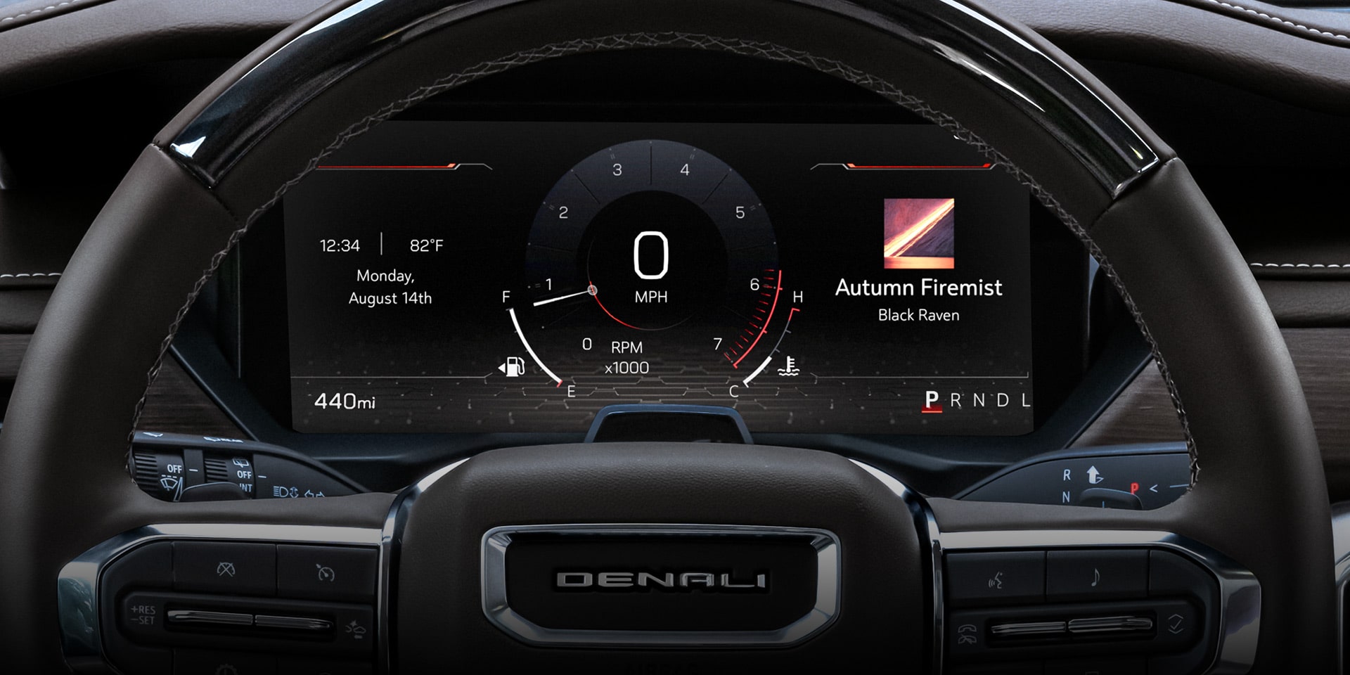 A Close-up of the Steering Wheel and Digital Instrument Cluster of a GMC Denali Vehicle, Displaying Speed, Mileage, and the Date