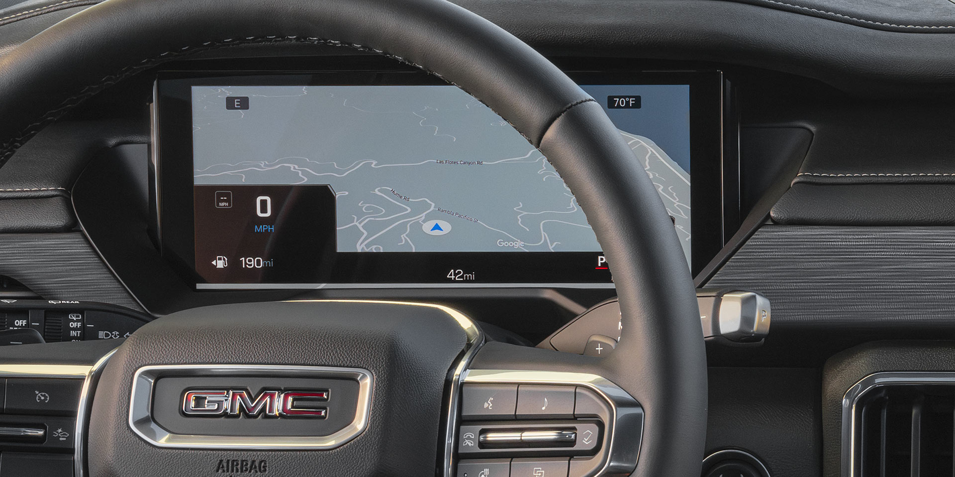 A Close-Up View of the GMC Steering Wheel and a Digital Display Showing a Map