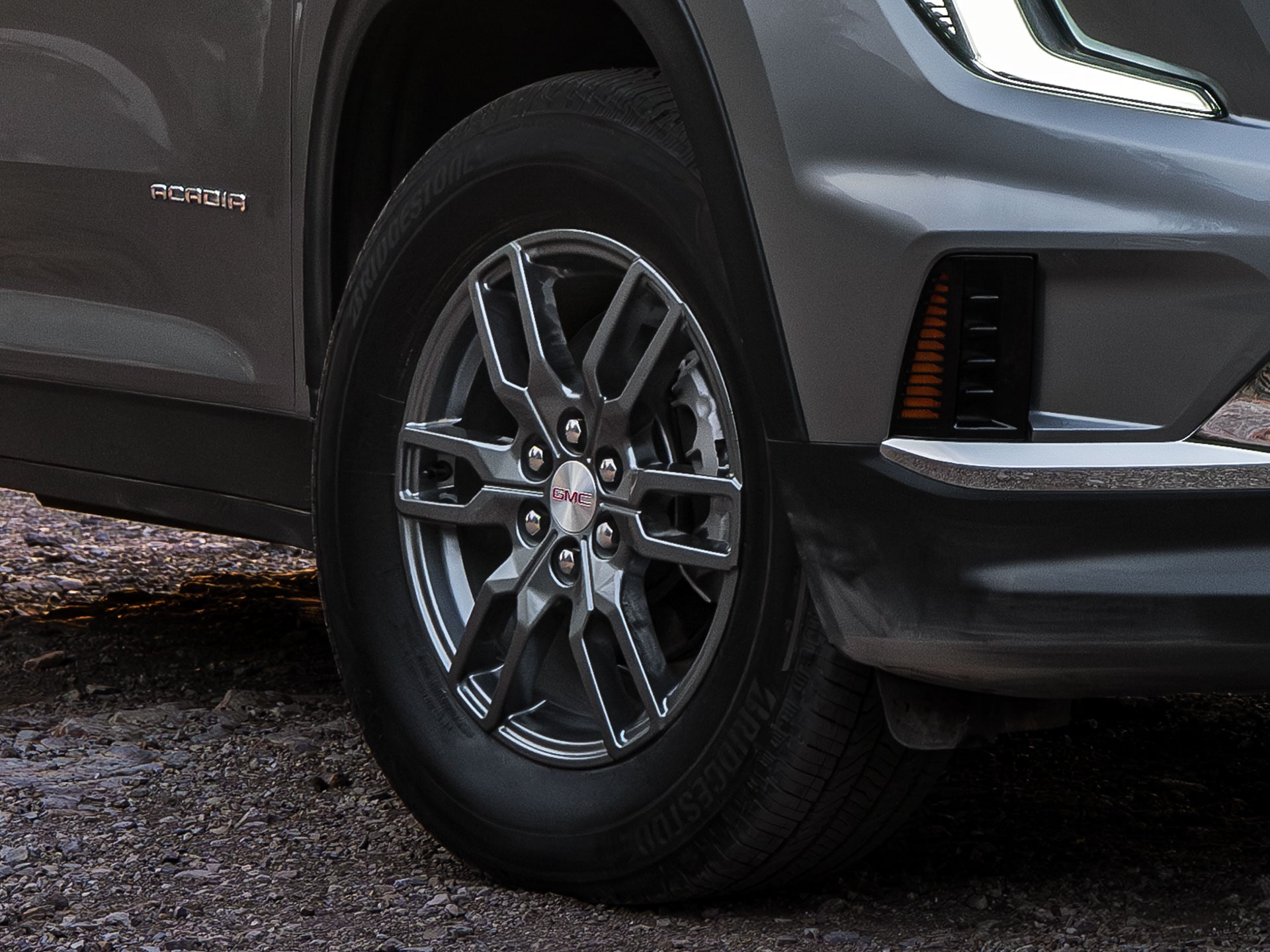 Close-Up Of the Front Lower Section And a Gray Multi-Spoke Wheel Of a Gray GMC SUV