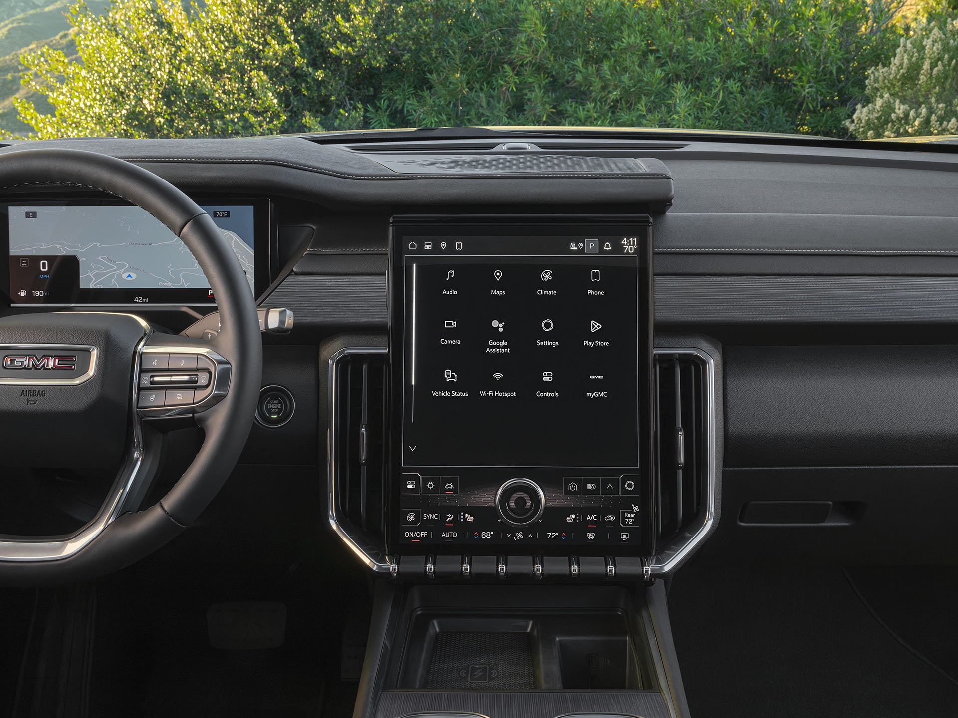 A Wide Interior Shot of a GMC Dashboard With a Vertical Infotainment Screen Displaying App Icons